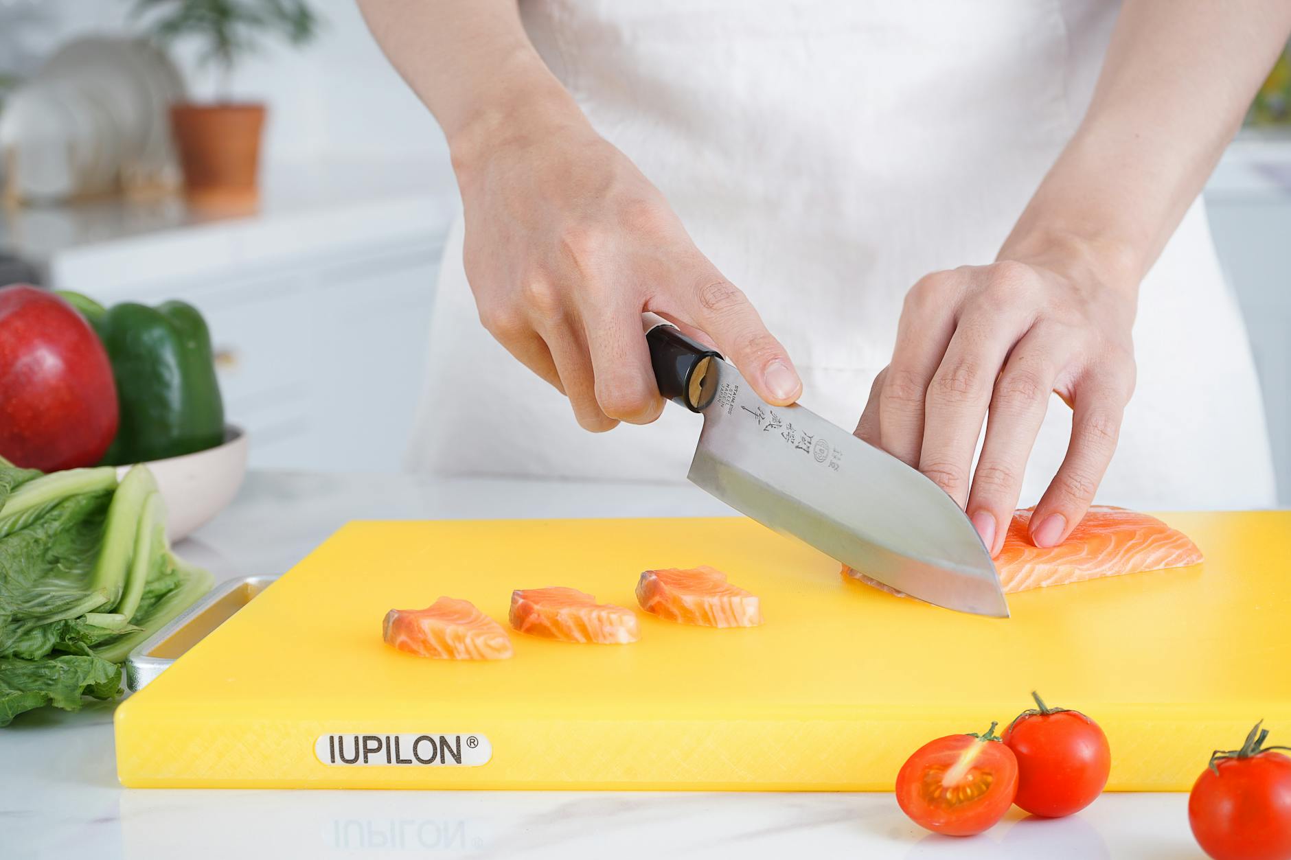 Japanese chef knife on a wooden cutting board