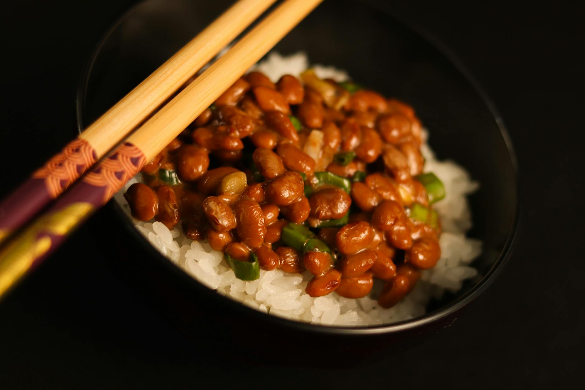 A bowl of fluffy Japanese rice with chopsticks